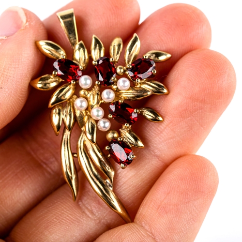 511 - A late 20th century 9ct gold garnet and pearl floral spray pendant, set with oval mixed-cut garnets,... 