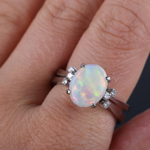 522 - A late 20th century 14ct white gold dress ring, set with oval cabochon white opal and round brillian... 