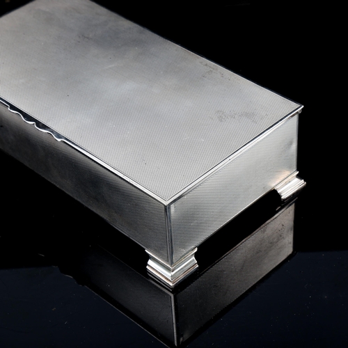 529 - A George VI rectangular silver cigarette box, allover engine turned decoration, by John Rose, hallma... 