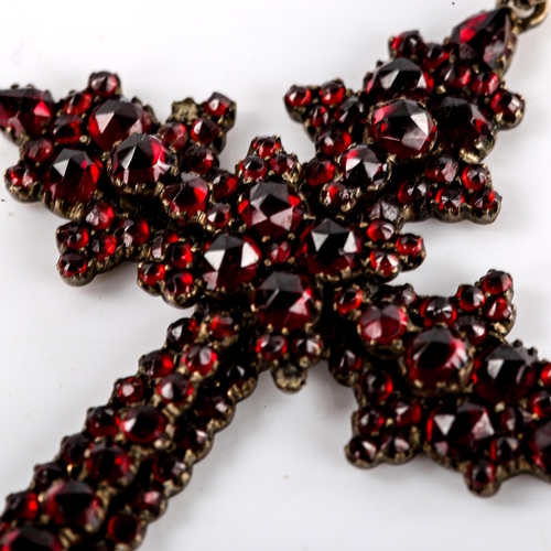 536 - A Victorian Bohemian faceted garnet cross pendant, unmarked yellow metal settings, pendant height 75... 