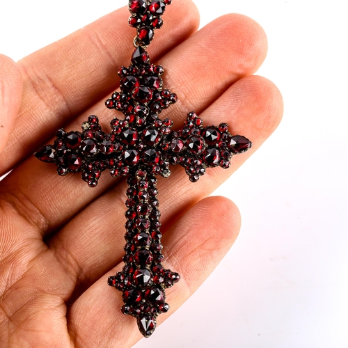 536 - A Victorian Bohemian faceted garnet cross pendant, unmarked yellow metal settings, pendant height 75... 