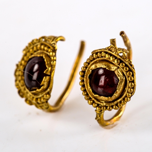 539 - A pair of Roman unmarked gold cabochon garnet earrings, beaded and lobed circular medallions, allege... 