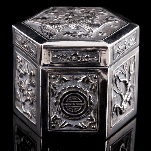 545 - A small Chinese hexagonal silver box and cover, relief embossed phoenix and floral decoration, with ... 