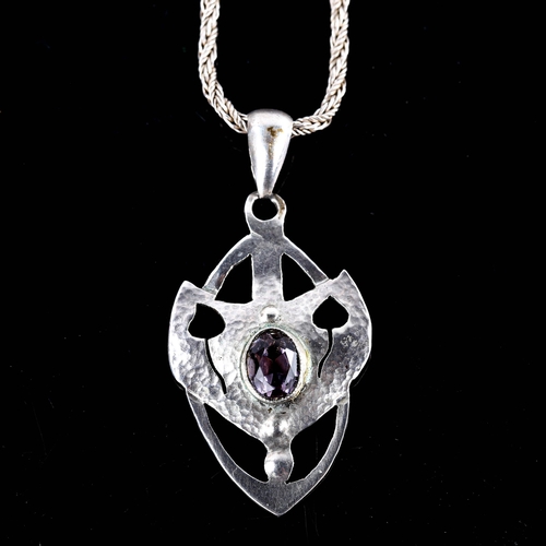 562 - An Arts and Crafts amethyst pendant necklace, unmarked white metal settings, with leaf design and tw... 