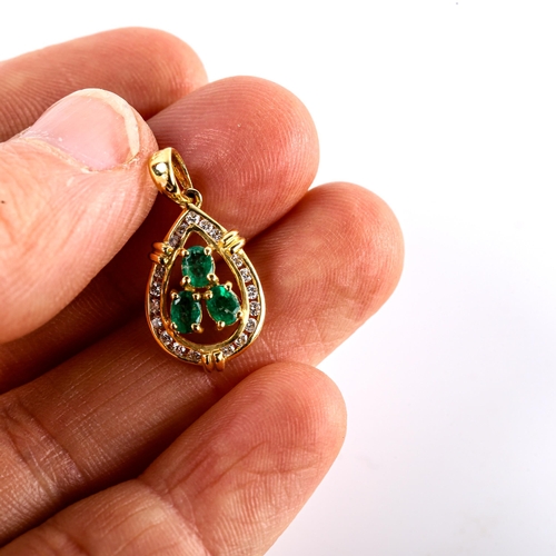 565 - A modern 18ct gold emerald and diamond pear cluster pendant, set with oval mixed-cut emeralds and ro... 