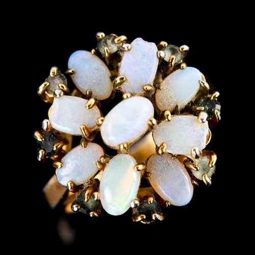 569 - A late 20th century gold plated opal and paste cluster flowerhead dress ring, set with oval cabochon... 