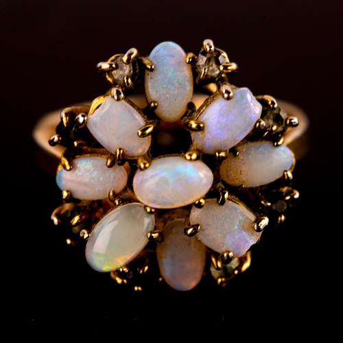 569 - A late 20th century gold plated opal and paste cluster flowerhead dress ring, set with oval cabochon... 