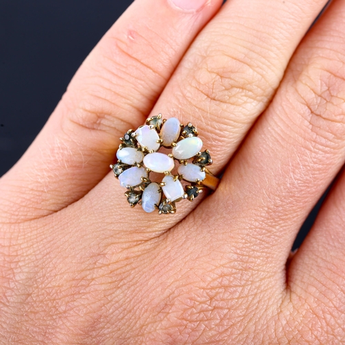 569 - A late 20th century gold plated opal and paste cluster flowerhead dress ring, set with oval cabochon... 