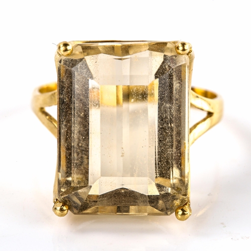 573 - A large Continental unmarked gold citrine dress ring, set with emerald-cut citrine, length 20mm, siz... 