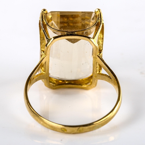 573 - A large Continental unmarked gold citrine dress ring, set with emerald-cut citrine, length 20mm, siz... 