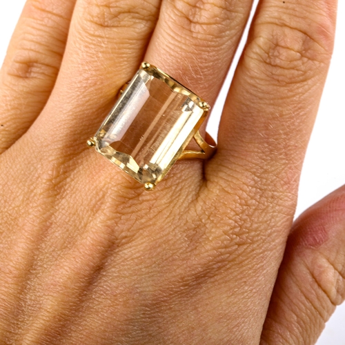 573 - A large Continental unmarked gold citrine dress ring, set with emerald-cut citrine, length 20mm, siz... 