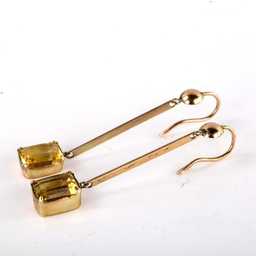 575 - A pair of citrine drop pendant earrings, unmarked yellow metal settings, with emerald step-cut citri... 