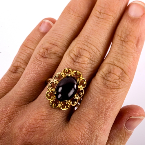 578 - A large late 20th century garnet dress ring, openwork settings with oval cabochon garnet, setting he... 