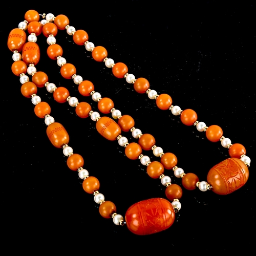 590 - A single-row amber bead and pearl sautoir necklace, with unmarked yellow metal spacers and carved am... 