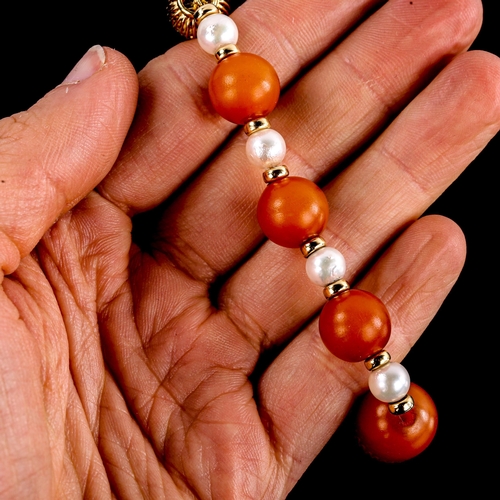 591 - An amber and pearl bead bracelet, with 14ct gold clasp and spacers, largest bead length 19.1mm, brac... 