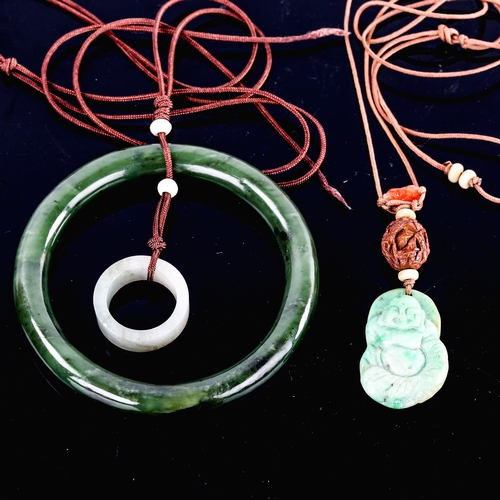 594 - A jade slave bangle, on cord pendant mount with jade ring, and another carved and polished jade Budd... 