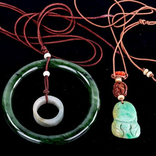 594 - A jade slave bangle, on cord pendant mount with jade ring, and another carved and polished jade Budd... 