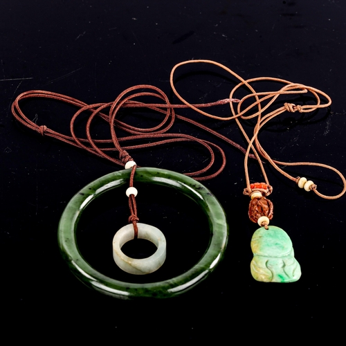 594 - A jade slave bangle, on cord pendant mount with jade ring, and another carved and polished jade Budd... 