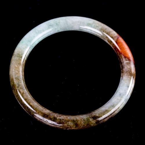 595 - A Chinese carved and polished jade slave bangle, overall diameter 7cm, 36.7g