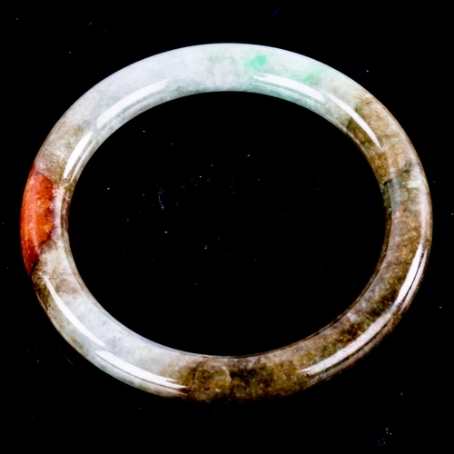 595 - A Chinese carved and polished jade slave bangle, overall diameter 7cm, 36.7g