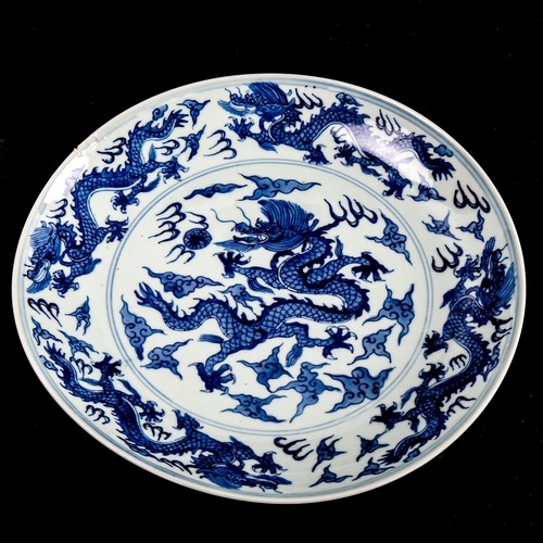 216 - A Chinese blue and white porcelain dragon bowl, 6 character mark, diameter 27cm