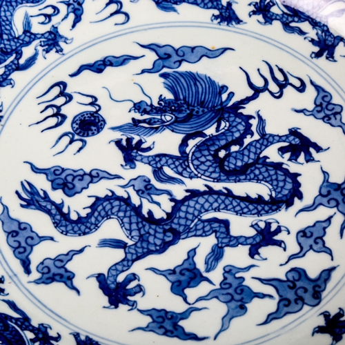 216 - A Chinese blue and white porcelain dragon bowl, 6 character mark, diameter 27cm