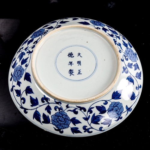 216 - A Chinese blue and white porcelain dragon bowl, 6 character mark, diameter 27cm