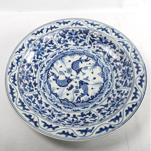 218 - A Chinese blue and white porcelain bowl with fish decoration, 6 character mark, diameter 36cm