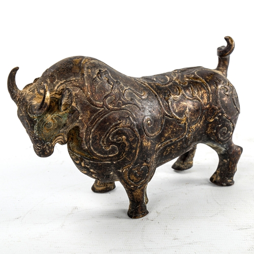 234 - A gilt patinated bronze bull, with relief moulded surface decoration, length 18cm