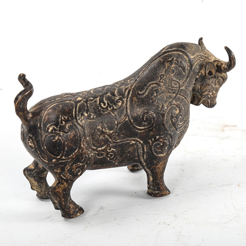 234 - A gilt patinated bronze bull, with relief moulded surface decoration, length 18cm