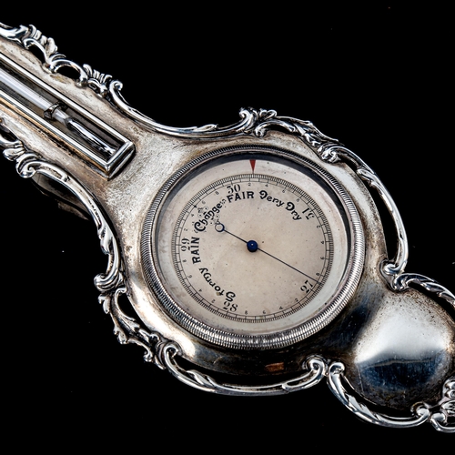 253 - An unusual miniature silver-cased banjo-shaped barometer and thermometer, with cast surround, length... 