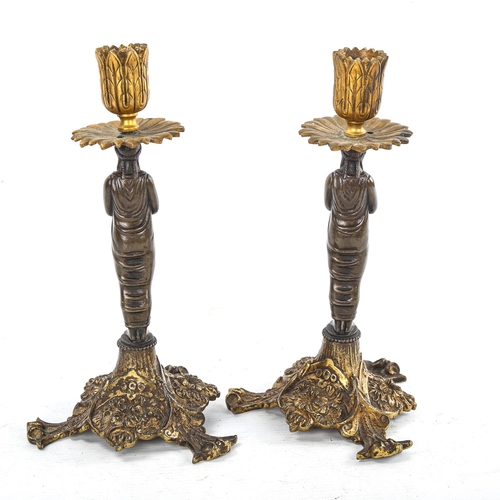 262 - A pair of patinated and gilded bronze candlesticks, supported by Classical figures, height 22cm