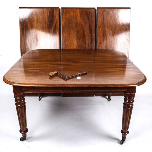 280 - A 19th century mahogany wind-out dining table, with turned and reeded legs, and 3 spare leaves