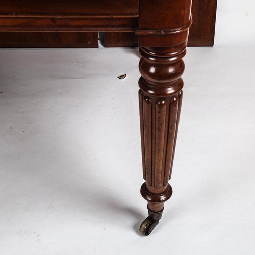 280 - A 19th century mahogany wind-out dining table, with turned and reeded legs, and 3 spare leaves