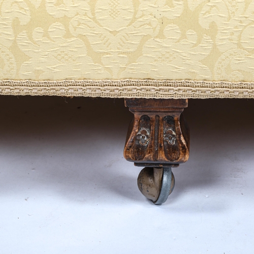 281 - An upholstered sofa, circa 1900, with serpentine-shaped back and rollover arms, on carved feet, over... 