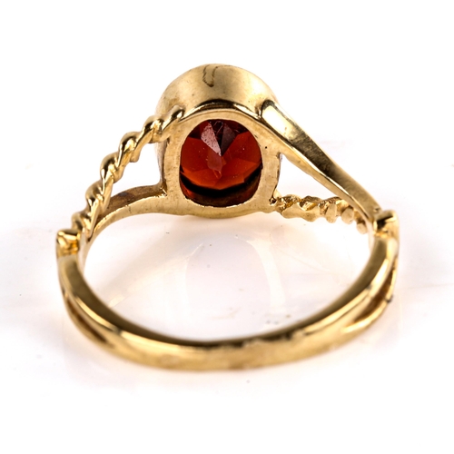 621 - A late 20th century unmarked gold garnet dress ring, set with oval mixed-cut garnet with rope twist ... 