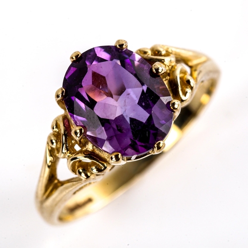 623 - A modern 9ct gold amethyst dress ring, set with oval mixed-cut amethyst and openwork shoulders, sett... 