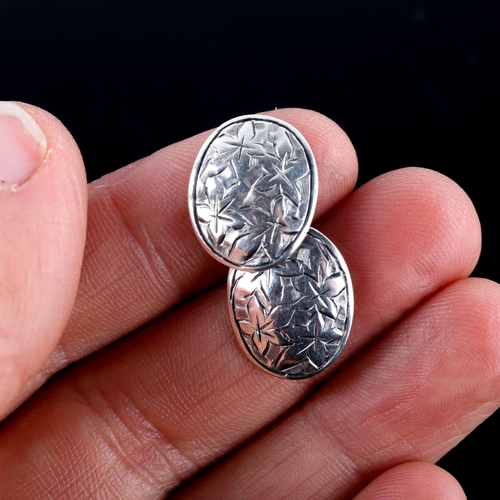 671 - A pair of early 20th century silver oval cufflinks, engraved floral decoration, by George Loveridge,... 