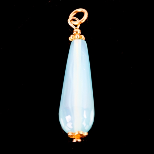 741 - A modern polished blue agate teardrop pendant, with unmarked yellow metal mounts, height excluding b... 