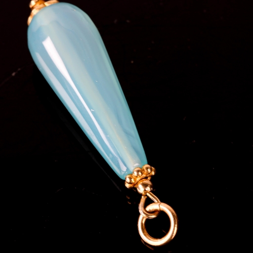 741 - A modern polished blue agate teardrop pendant, with unmarked yellow metal mounts, height excluding b... 