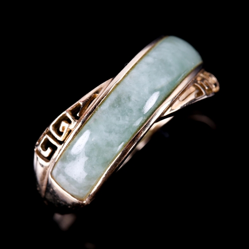 743 - A modern 9ct gold jade dress ring, with pierced Greek key shoulders, setting height 7.8mm, size M, 2... 