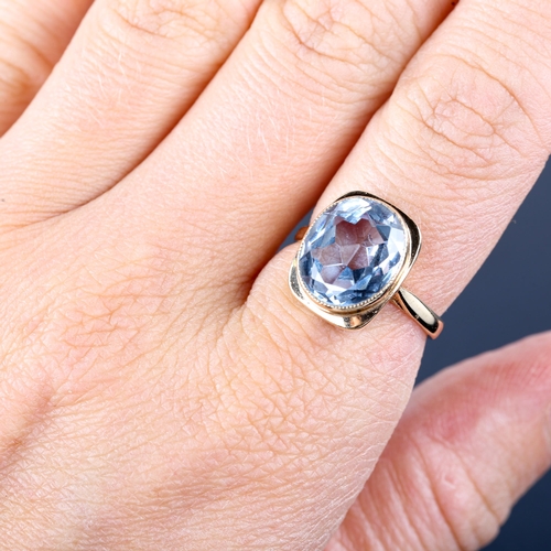 749 - A late 20th century 9ct gold blue topaz dress ring, bezel set with oval mixed-cut topaz, hallmarks B... 