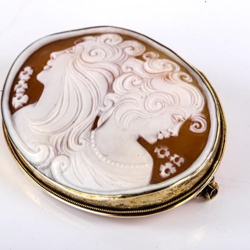 771 - A Vintage German carved shell cameo brooch, depicting 2 female profiles, in German silver-gilt frame... 