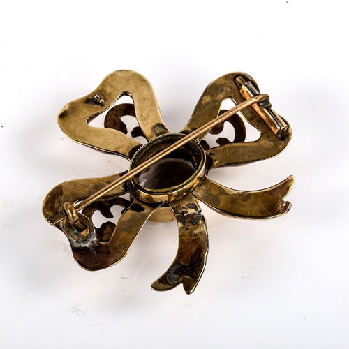 772 - A large Victorian smoky quartz ribbon bow brooch, unmarked yellow metal settings with foliate engrav... 