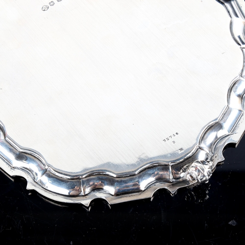 777 - A George VI circular silver salver, scalloped rim with scrolled acanthus leaf feet, by William Hutto... 