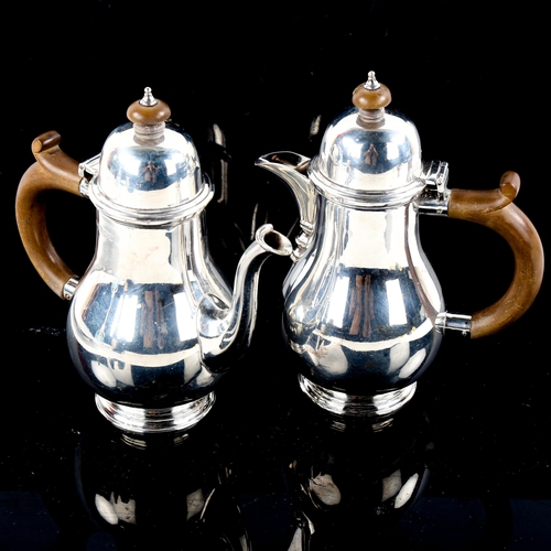 778 - A George VI matching silver bachelor's coffee pot and hot water jug, baluster form with turned wood ... 