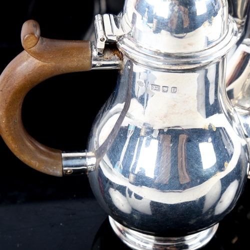 778 - A George VI matching silver bachelor's coffee pot and hot water jug, baluster form with turned wood ... 