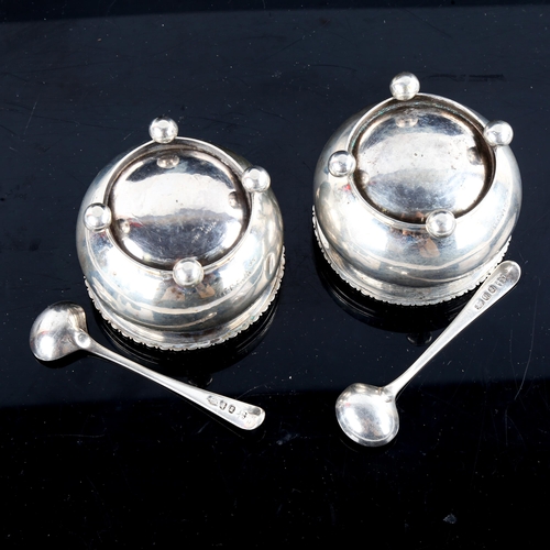 779 - A pair of George III silver salt cellars, bulbous circular form with gadrooned rim, bun feet and gil... 