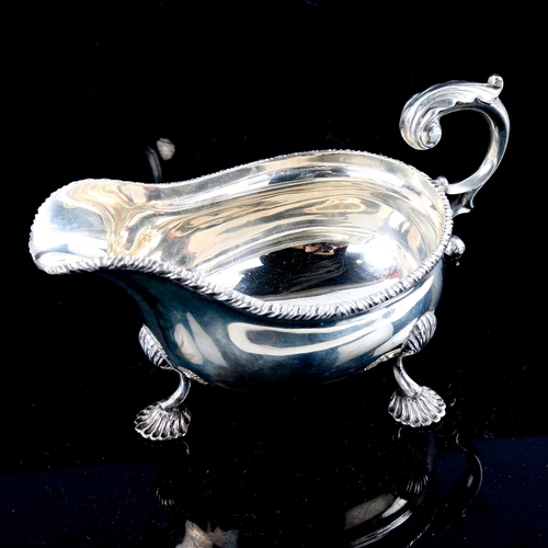 780 - An Edwardian silver sauce boat, gadrooned rim with shell feet and scrolled C-shape acanthus leaf han... 