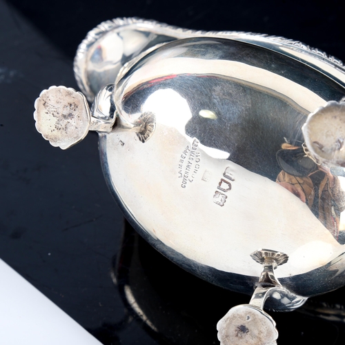 780 - An Edwardian silver sauce boat, gadrooned rim with shell feet and scrolled C-shape acanthus leaf han... 